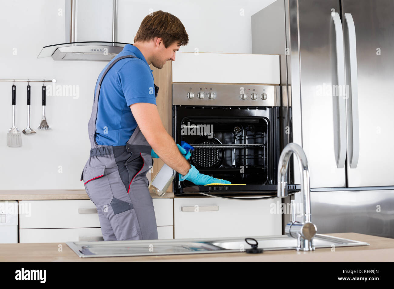 Man cleaning oven in hi-res stock photography and images - Alamy