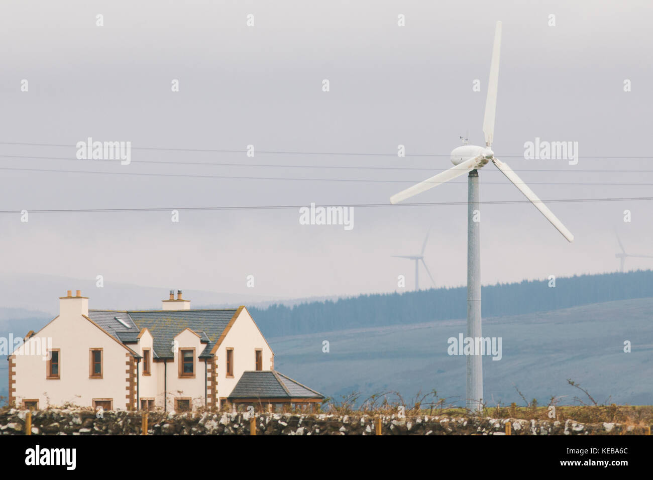 Picture of Modern house with wind turbines near mountains Stock Photo - Alamy