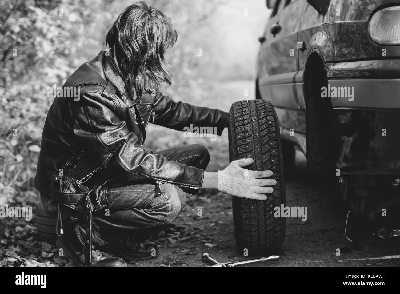 Change a flat car tire on road with Tire maintenance, damaged car tyre