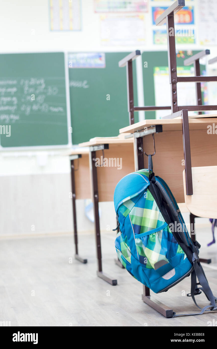 School classroom with school desks and blackboard Stock Photo