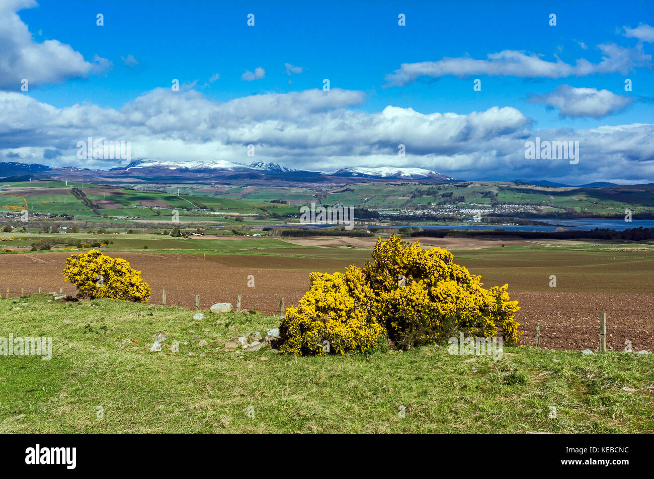 View across Cromarty Firth to Dingwall from the Black Isle near Easter Kinkell in Highland Scotland with Ben Wyvis in the distance Stock Photo