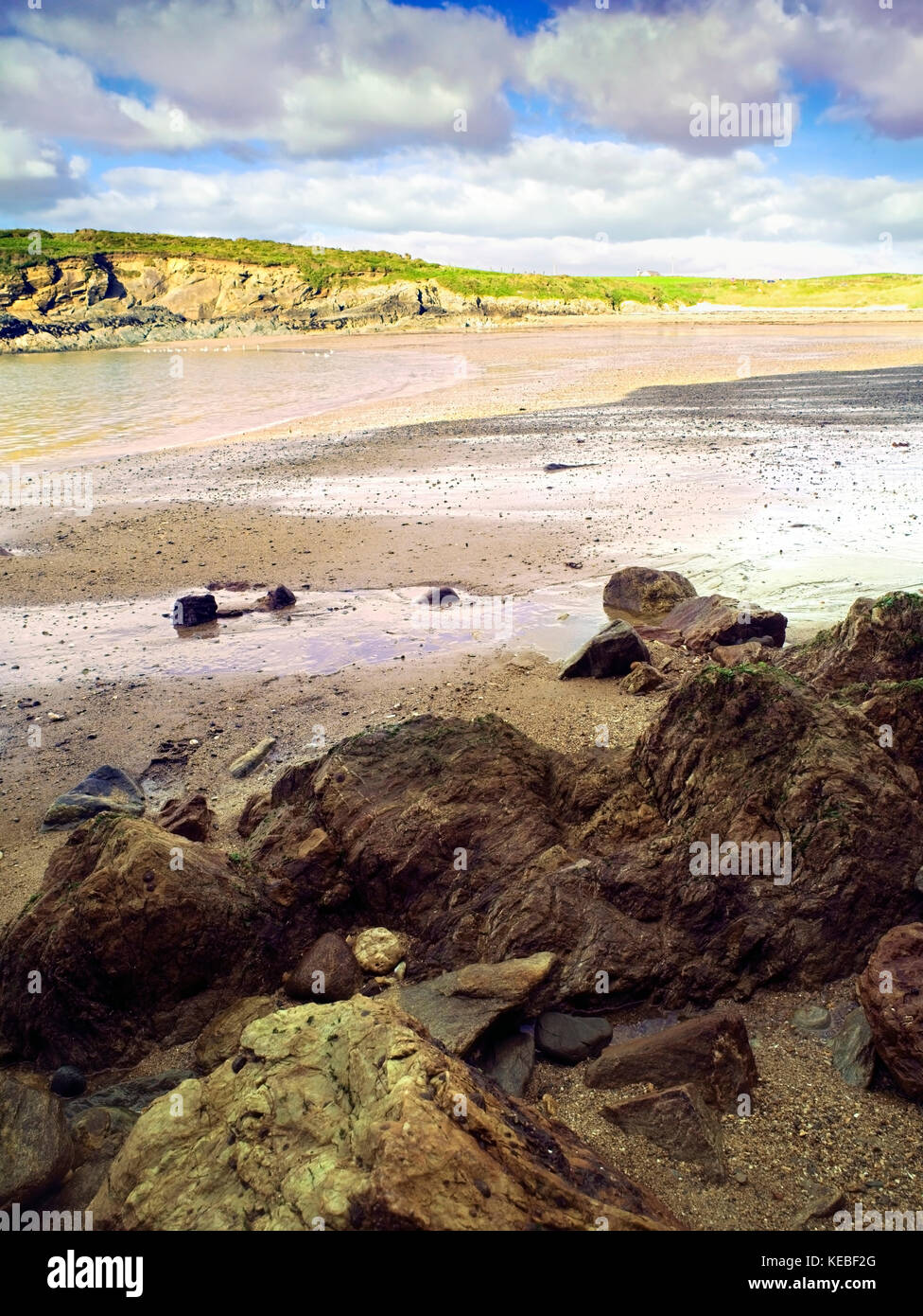 A summer view of the sandy beach of Porth Trecastell, or Cable Bay, on the Isle of Anglesey, Wales, UK Stock Photo