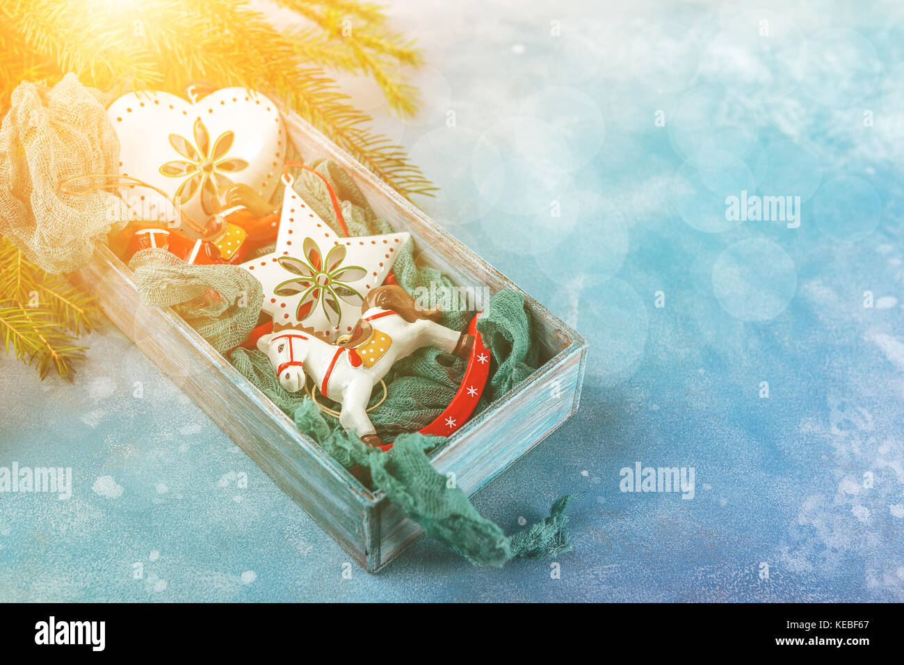 Christmas toys in wooden box under the branches of Christmas tree and