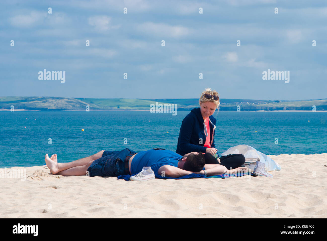 A couple relaxing on the beach. Stock Photo