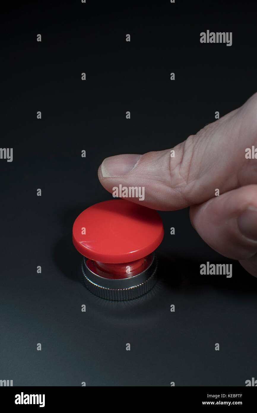 Big red button - metaphor for 'Finger on the Button'. Photographer's hand  in shot (see additional info re. MR Stock Photo - Alamy