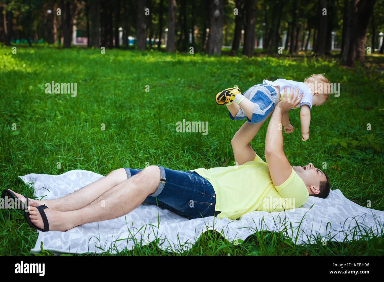 happy father and his son on grass Stock Photo - Alamy