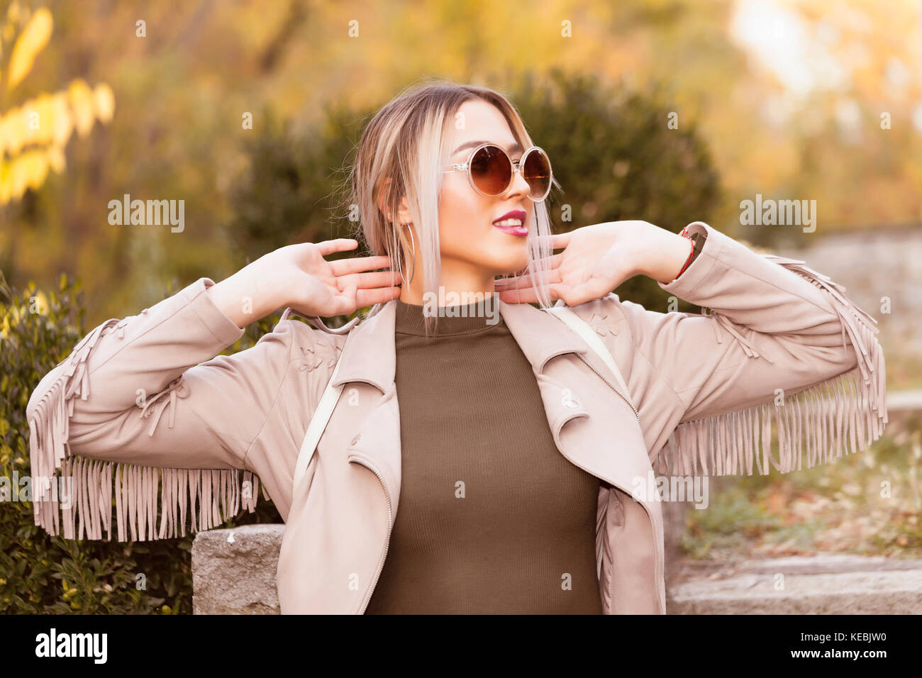 Portrait of a beautiful young modern and urban woman outside with ...