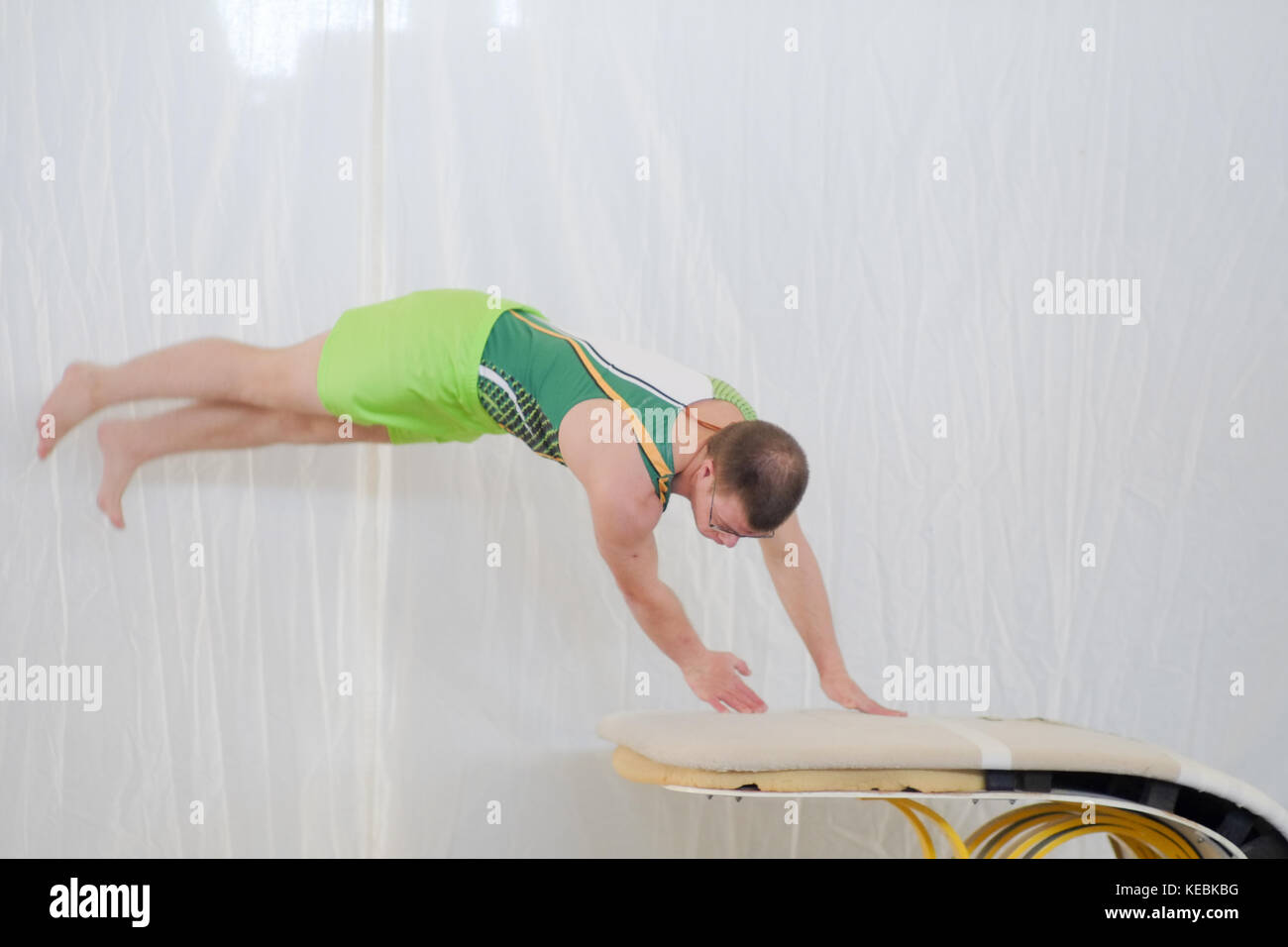 Down syndrome young boy performing indoor at gym horse during a championship competition Trisome Games 2016. Florence, Italy. Stock Photo