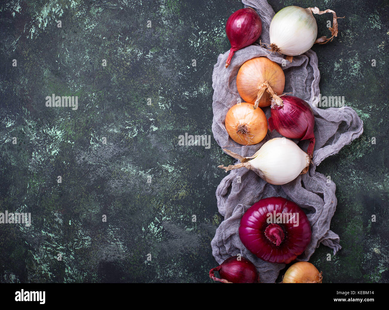 Various type of onions on green background Stock Photo - Alamy