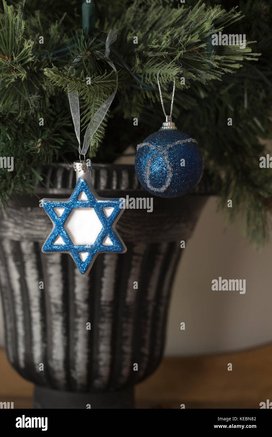 Hanukkah and Christmas decorations side by side on Christmas tree Stock Photo