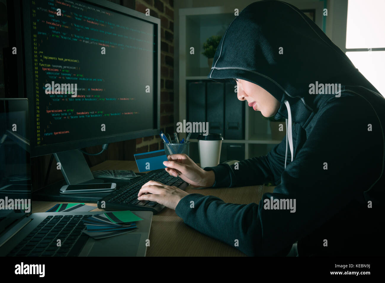 evil pretty woman hacker stealing personal identity credit card information and using account making trading through online data code. Stock Photo