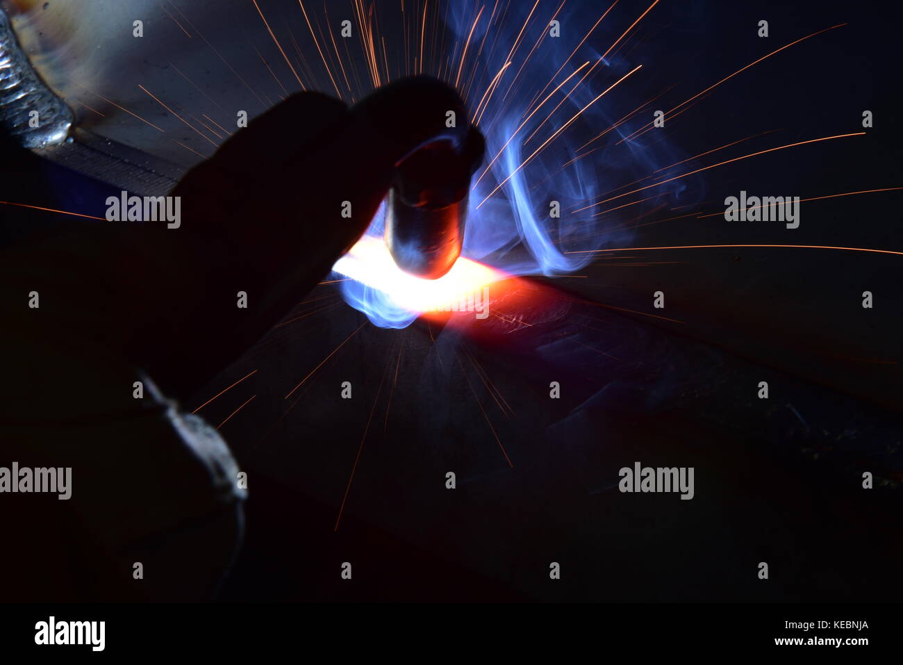 Metal Welding with sparks and smoke metal welding Stock Photo