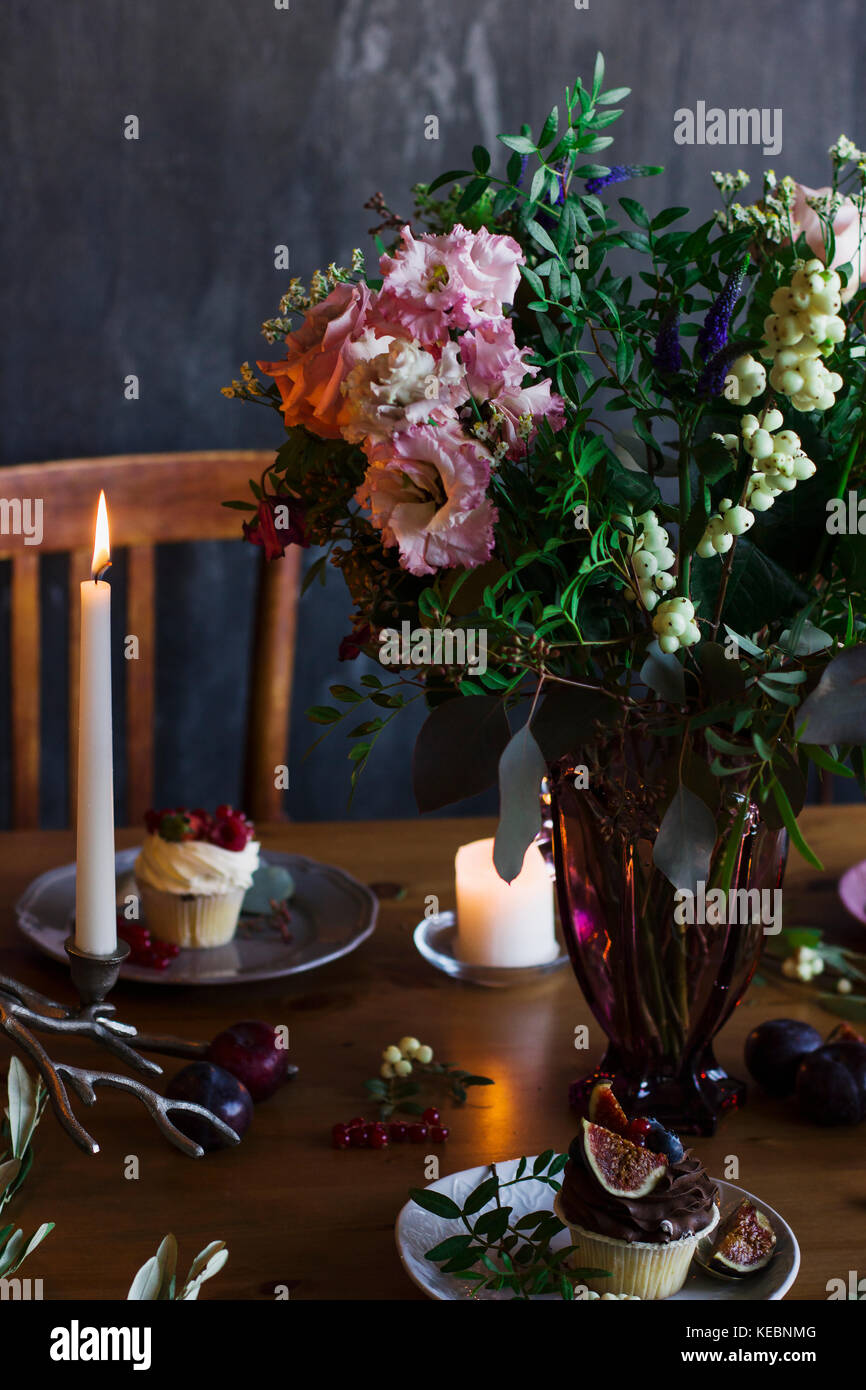 The beautiful rustic bouquet of flowers on festive table Stock Photo
