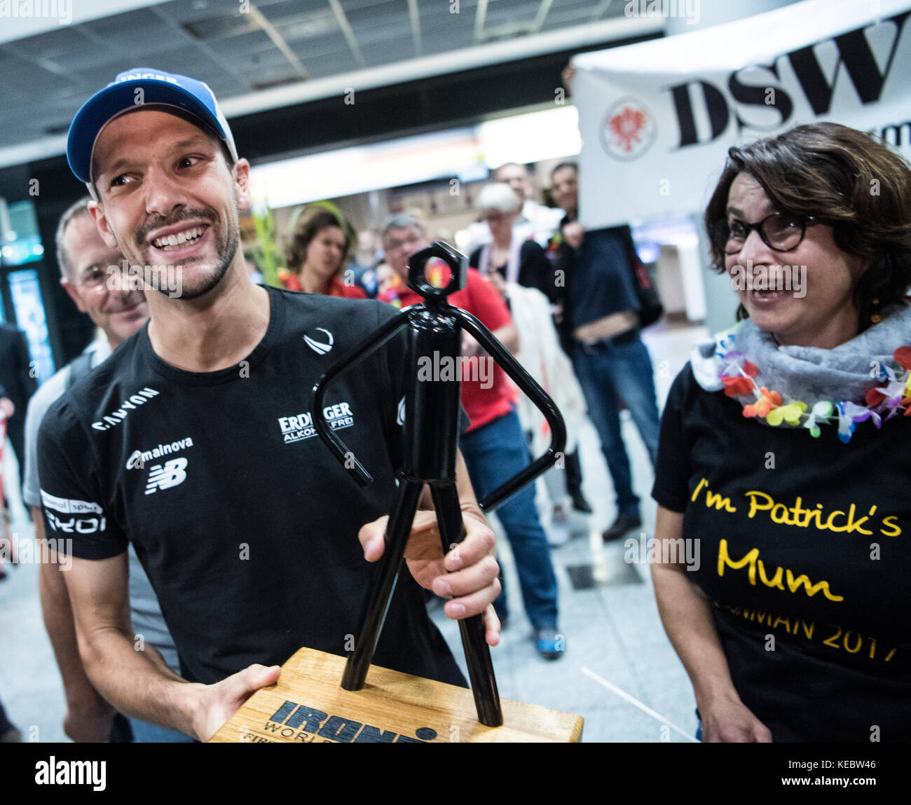 Frankfurt am Main, Germany. 19th Oct, 2017. Ironman World Champion Patrick Lange is received by supporters, among them his mother Carmen, at the airport in Frankfurt am Main, Germany, 19 October 2017. Partick Lange has won the Ironman World Championships in Hawaii with a new record time. Credit: Andreas Arnold/dpa/Alamy Live News Stock Photo
