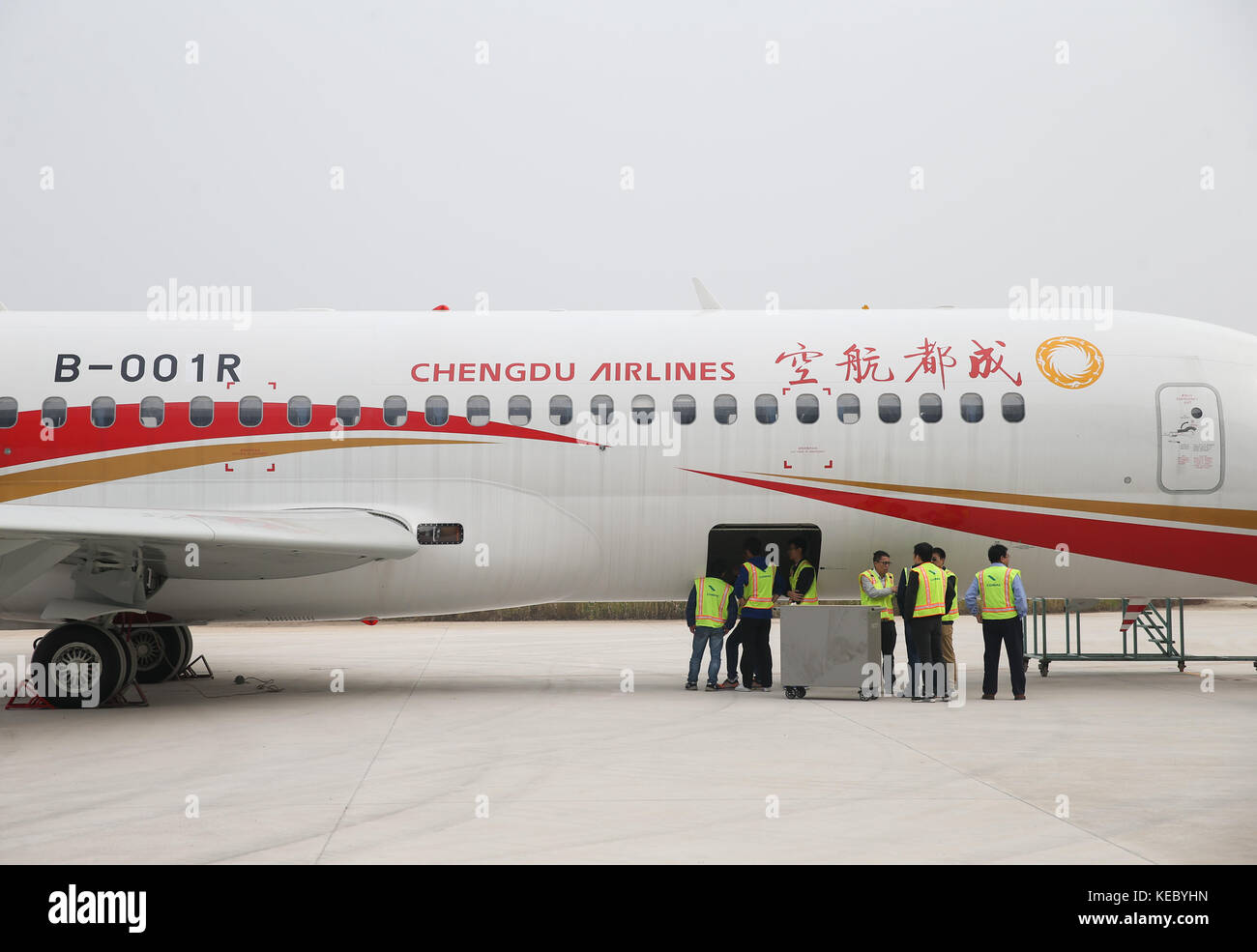 (171019) -- SHANGHAI, Oct. 19, 2017 (Xinhua) -- Photo taken on Oct. 14, 2017 shows staff workers maintaining the ARJ21-700 jetliner at Shengli Airport in Dongying of east China's Shandong Province. China's first domestic regional jetliner ARJ21-700 was delivered Thursday after its mass production was certified in July. The ARJ21-700 jetliner has 90 economy seats and was bought by China Aerospace Leasing Company, and delivered to Chengdu Airlines. The Commercial Aircraft Corporation of China (COMAC) obtained a production license to build the airliner from the General Administration of Civil Avi Stock Photo