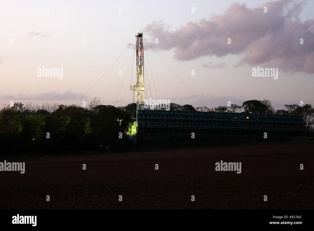 York, North Yorkshire, UK. 15th Oct, 2017. A Hydraulic Fracking Rig some hundred yards from Anti-Fracking protests and owned by ''Third Energy'' starts its evening operating lights as night draws in across the fields.Two Anti-Fracking protestors from the Kirby-Misperton Anti-Fracking camp in North Yorkshire were arrested shortly after they ended a 24 hour lock-on to a wooden tower which blocked the main gate of Fracking Company ''Third Energy'' in North Yorkshire. Heavily outnumbered by North Yorks Police the protestors defied heavy handed and obstructive tactics towards both Stock Photo