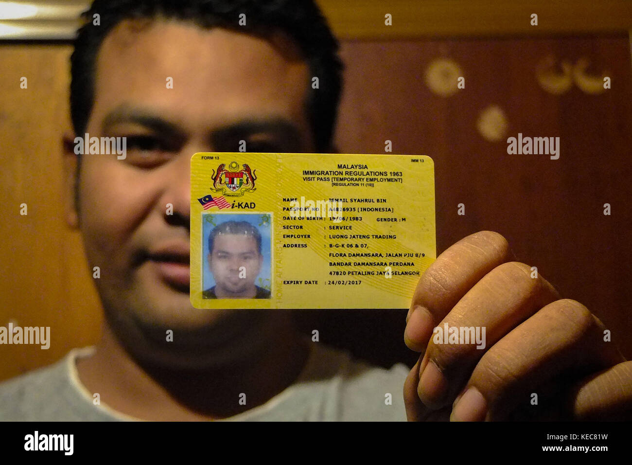 Kuala Lumpur, Selangor, Malaysia. 21st Nov, 2016. Syahrul holding his visa  and working permit proudly. He first arrived to Malaysia illegaly and after  he made a sufficient money then he made all