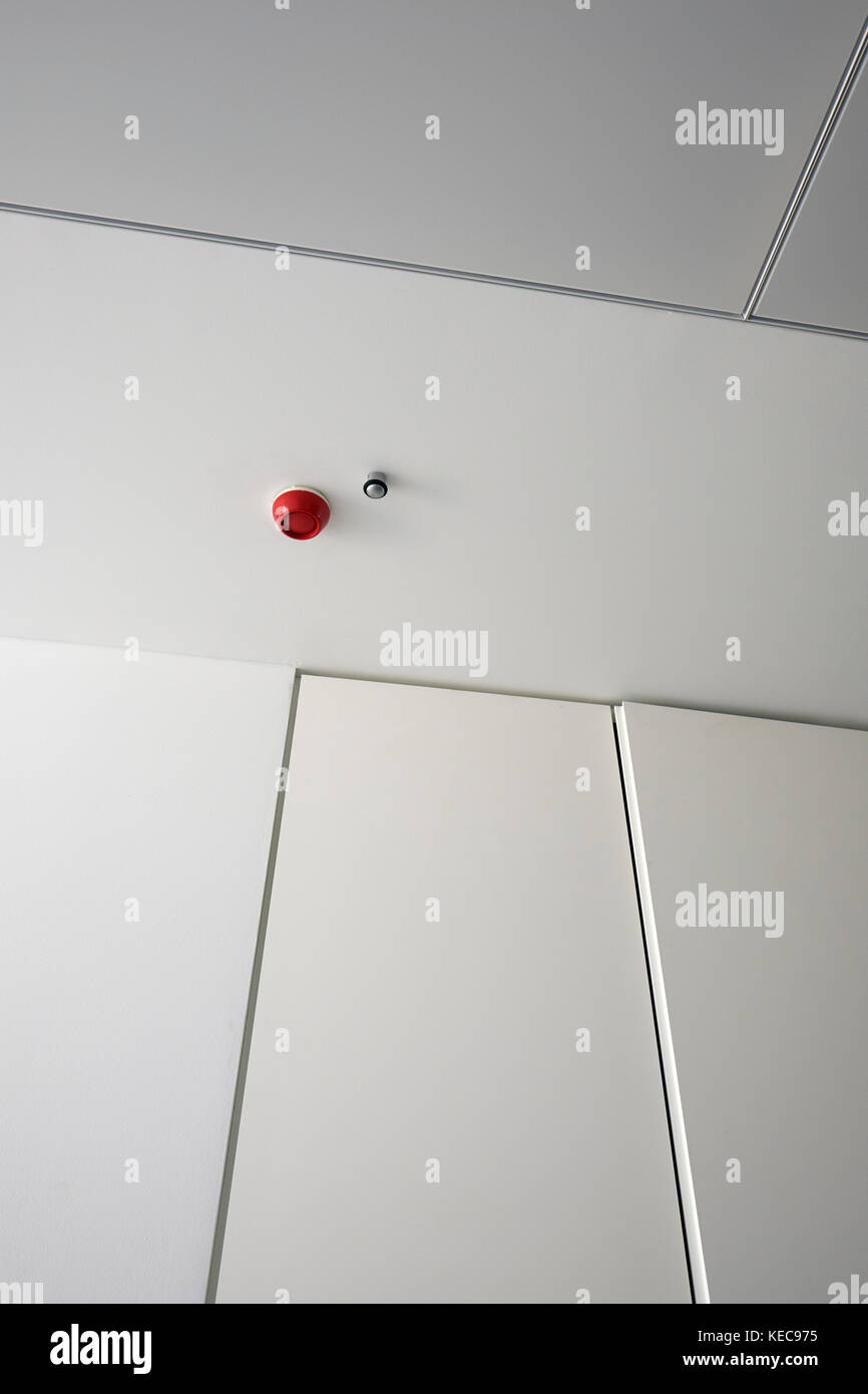 A red fire alarm in a white modern building. Stock Photo