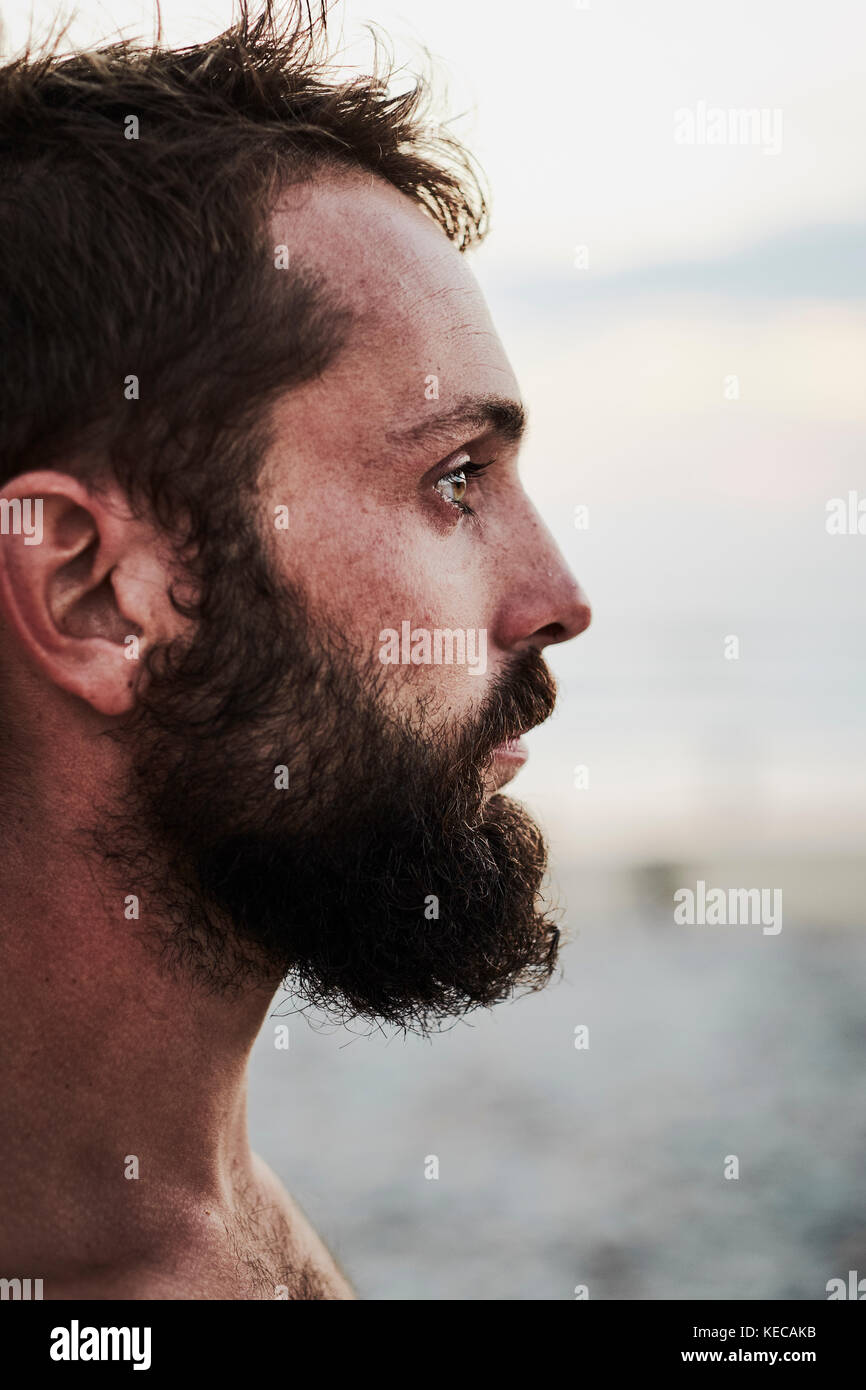 A close up portrait of a bearded surfer at the beach. (minimal focus) Stock Photo
