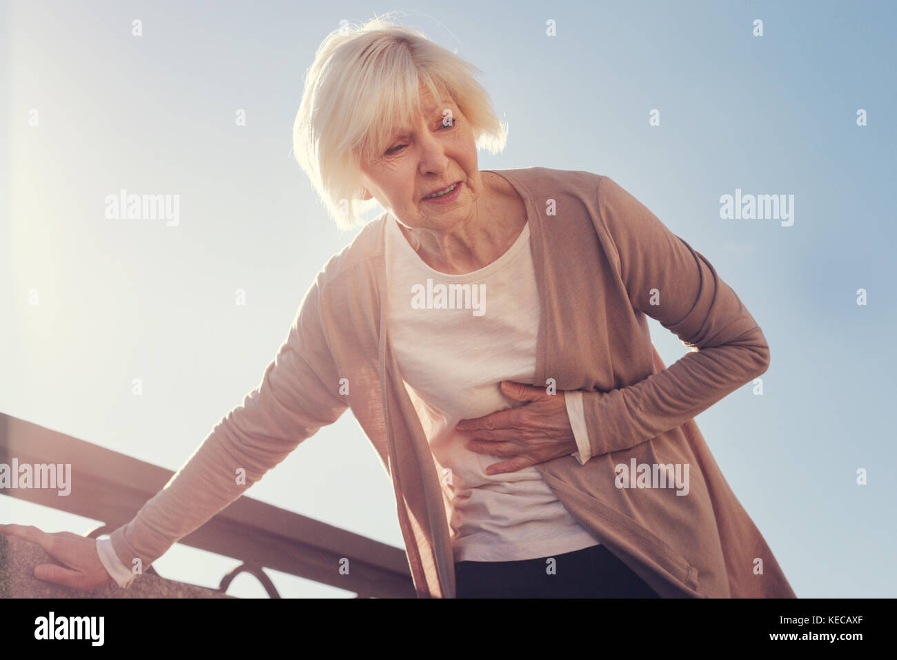 Senior woman suffering from pain in subcostal area Stock Photo - Alamy