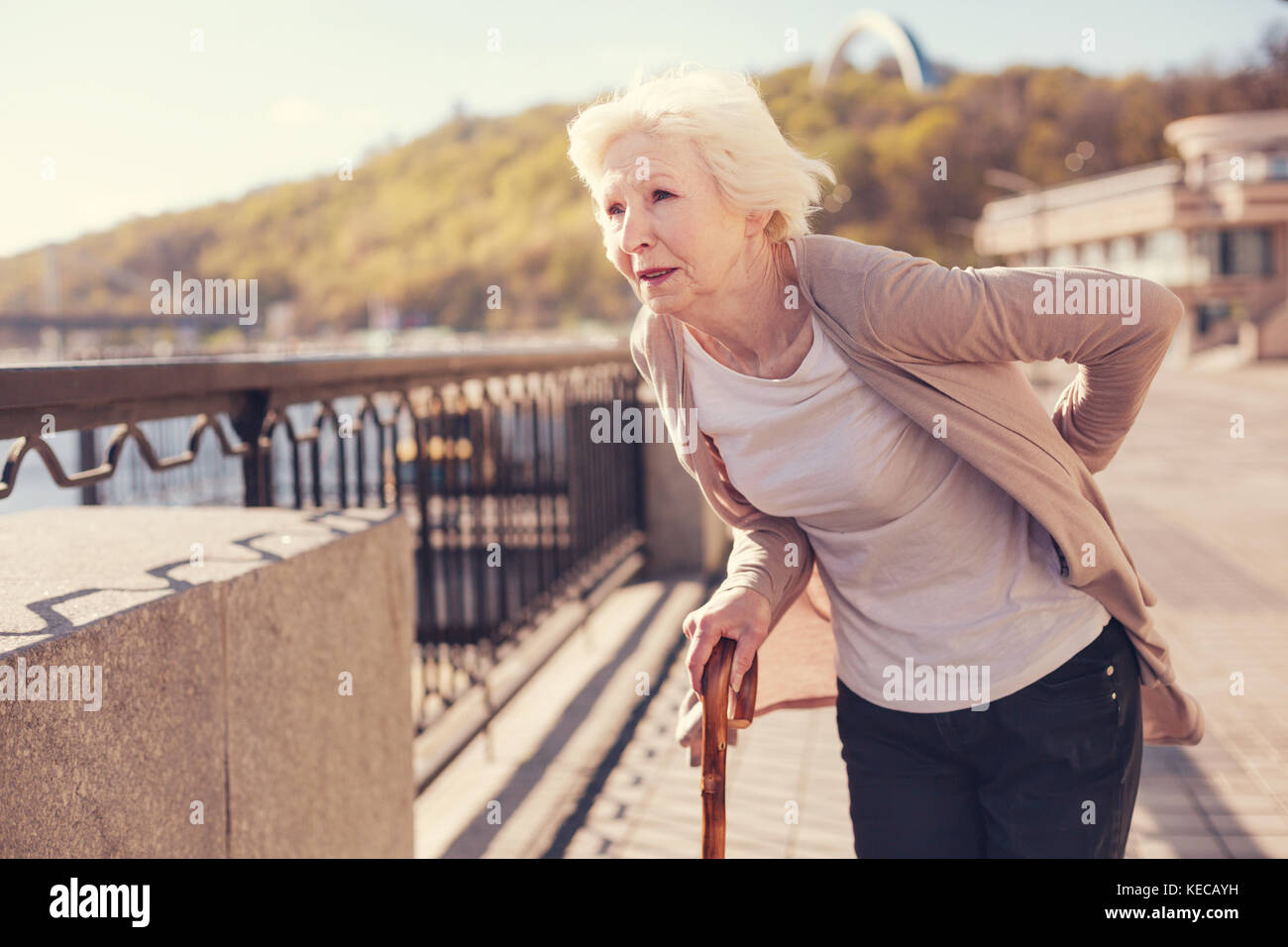 Pleasant senior woman suffering from lower back pain Stock Photo