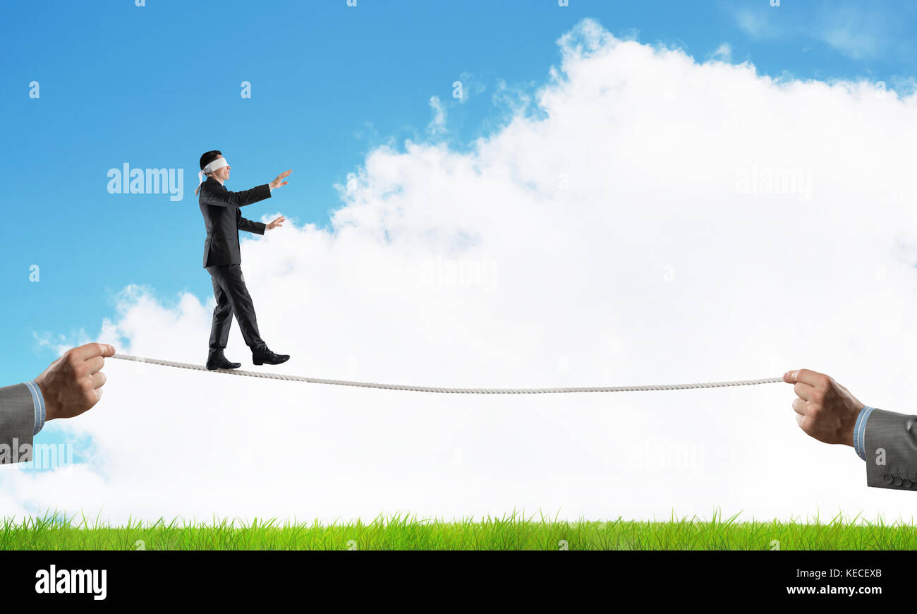 Business concept of risk support and assistance with man balancing on ...