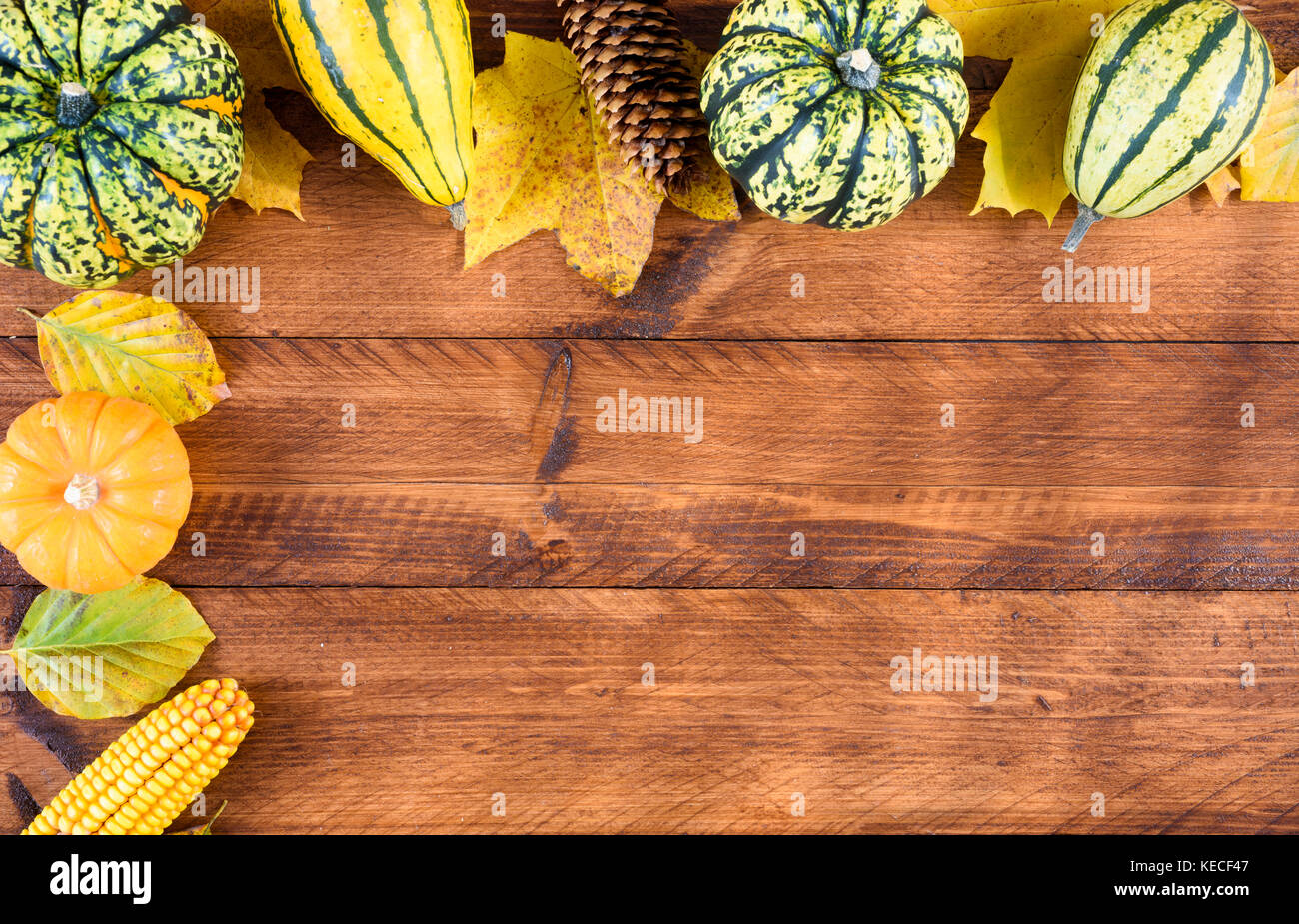 pumpkins and leaves at thanksgiving on wooden plank Stock Photo - Alamy
