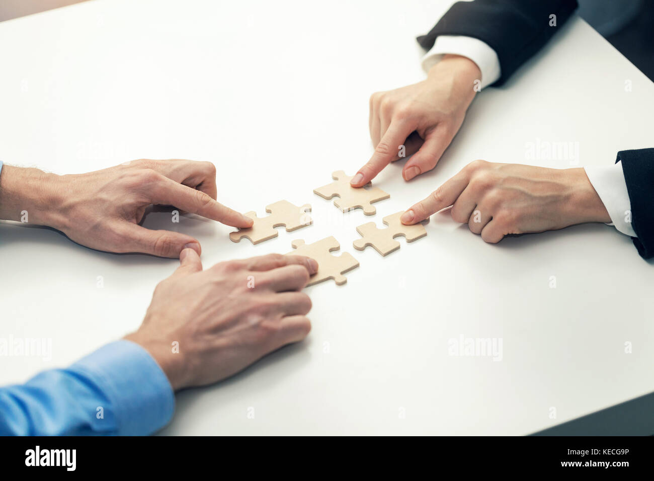 business cooperation concept - businessmen's  connecting puzzle pieces Stock Photo