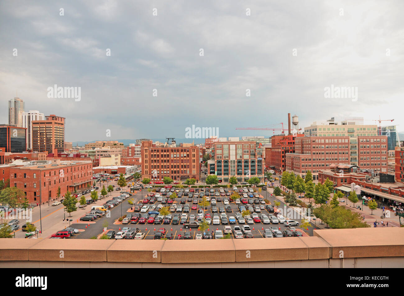 A Down Town Denver Parking Lot With Cars and Tall Buildings Stock Photo
