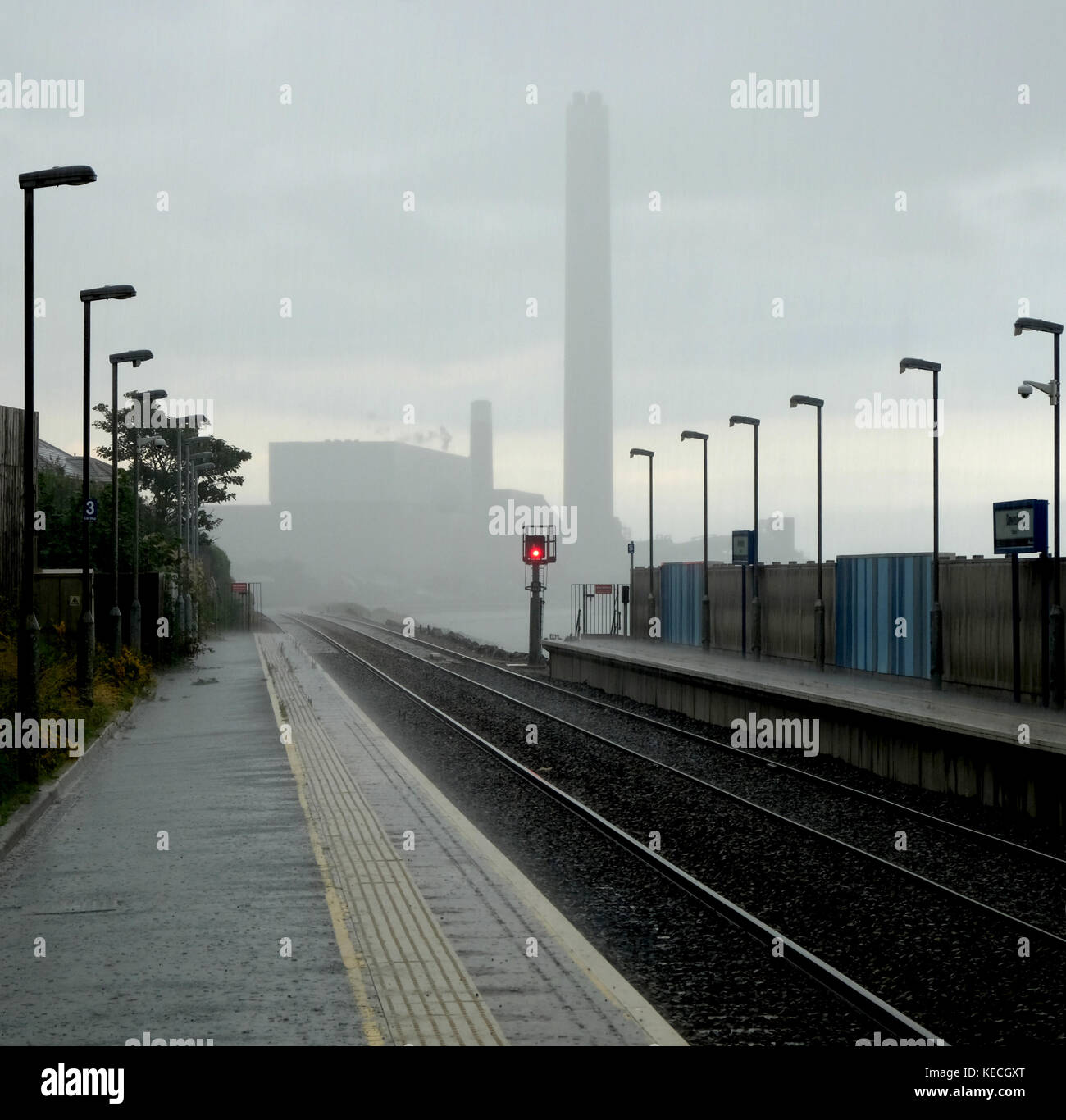 Wet day on Downshire railway station, Kilroot power station in distance Stock Photo