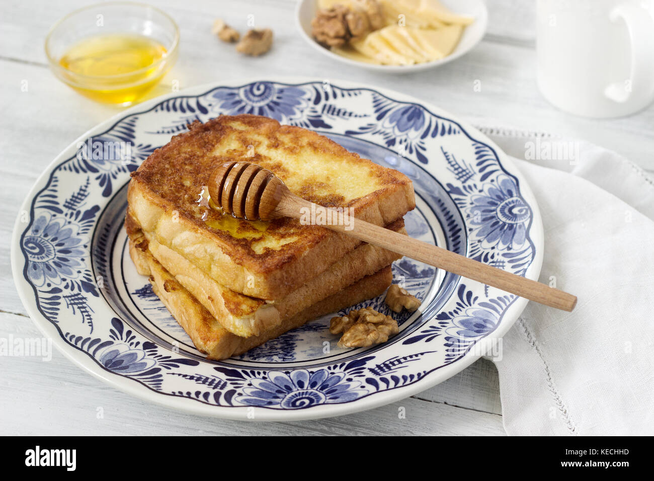French toast served with honey, nuts and cheese. Rustic style ...