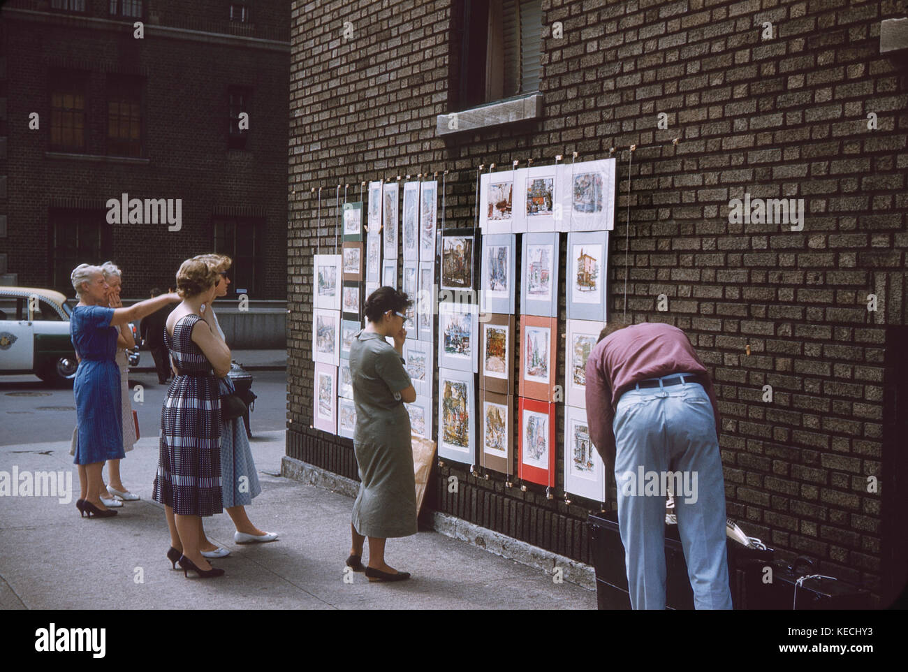 Group of Women Viewing Art from Vendor on Street Corner, New York City, New York, USA, July 1961 Stock Photo
