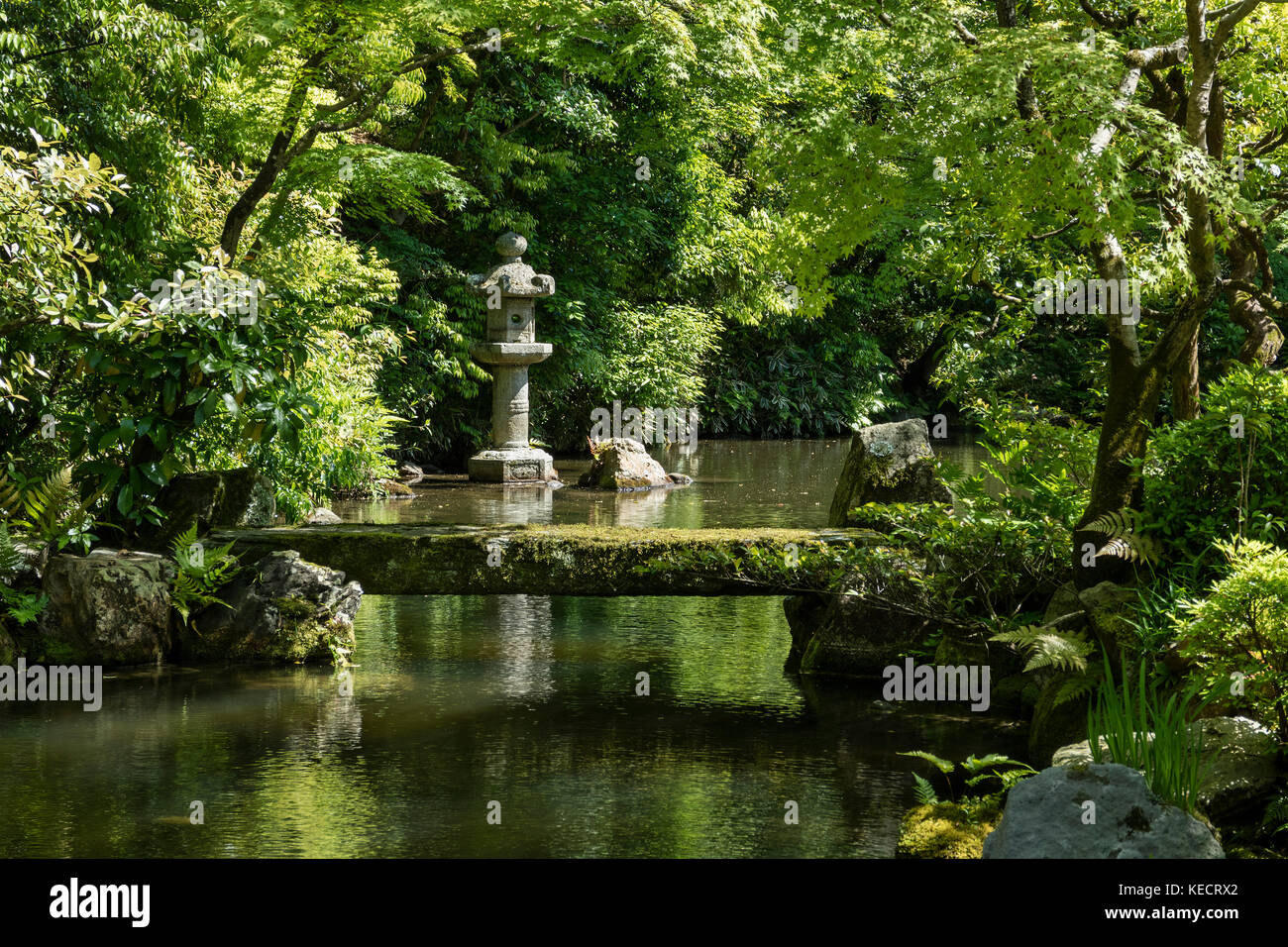 Kyoto, Japan - May 19, 2017: View of the Hojo Garden at Chion-in Buddhist temple with a traditional stone lantern in the pond Stock Photo