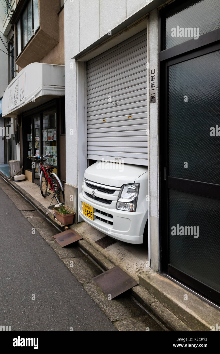 Kyoto, Japan -  May 23, 2017: Japanese car does not fit into the small garage in the street in Kyoto Stock Photo