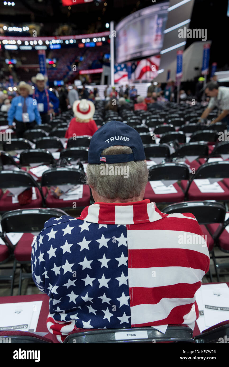 A Trump supporter wearing an American flag shirt waits for the start of the Republican National Convention July 20, 2016 in Cleveland, Ohio. Stock Photo