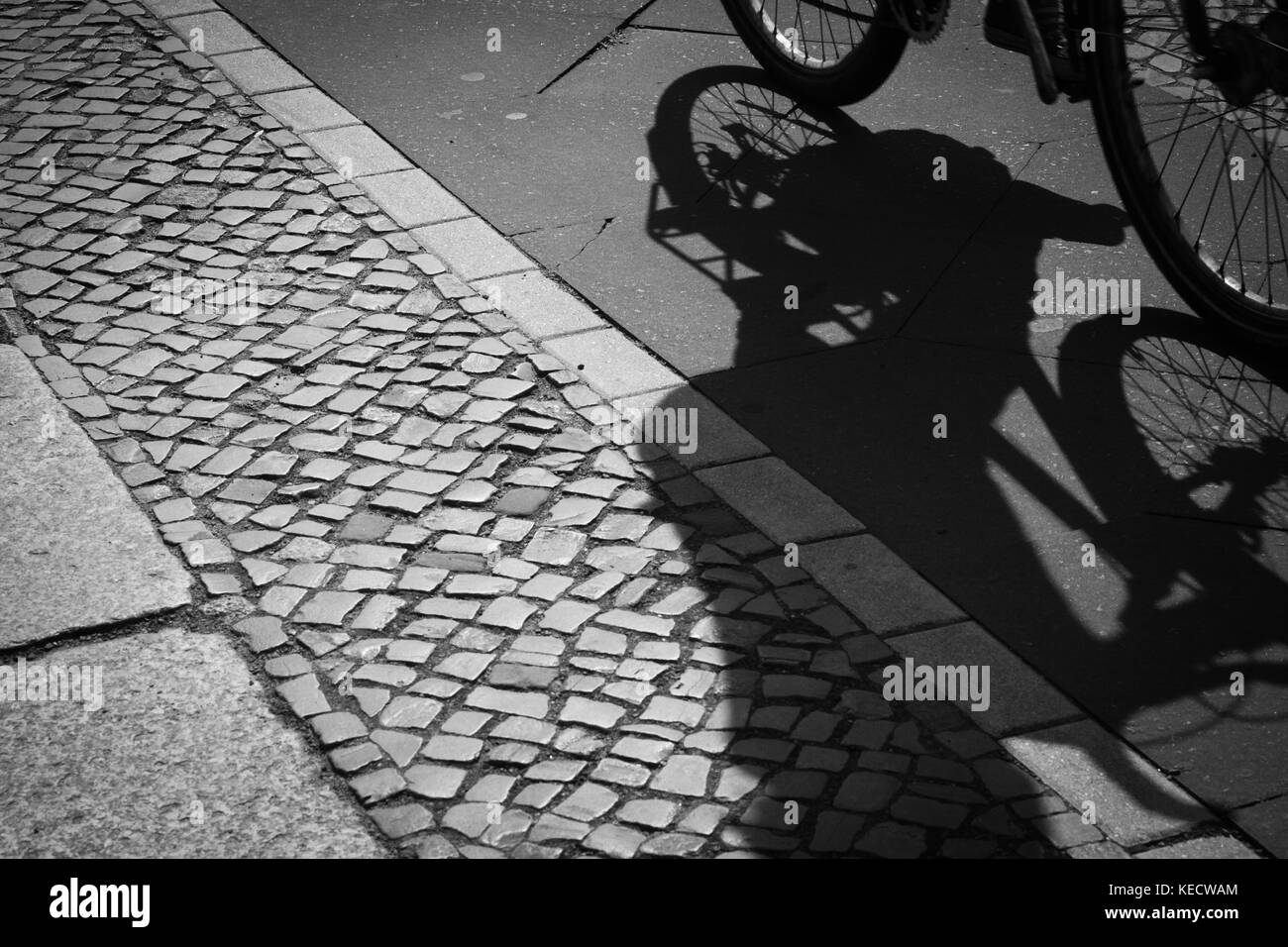 cyclist silhouette and shadow on bike lane Stock Photo