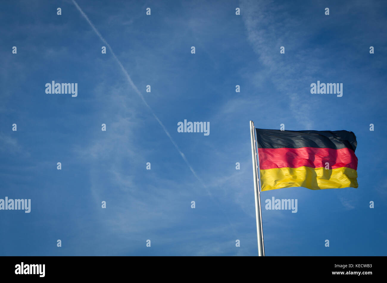 german flag blowing in the sky Stock Photo - Alamy