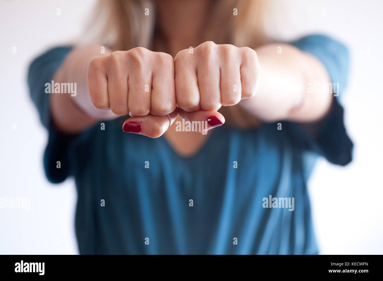 woman give a double punch, protecting herself. boxe fist. concept of defence, security, strength
