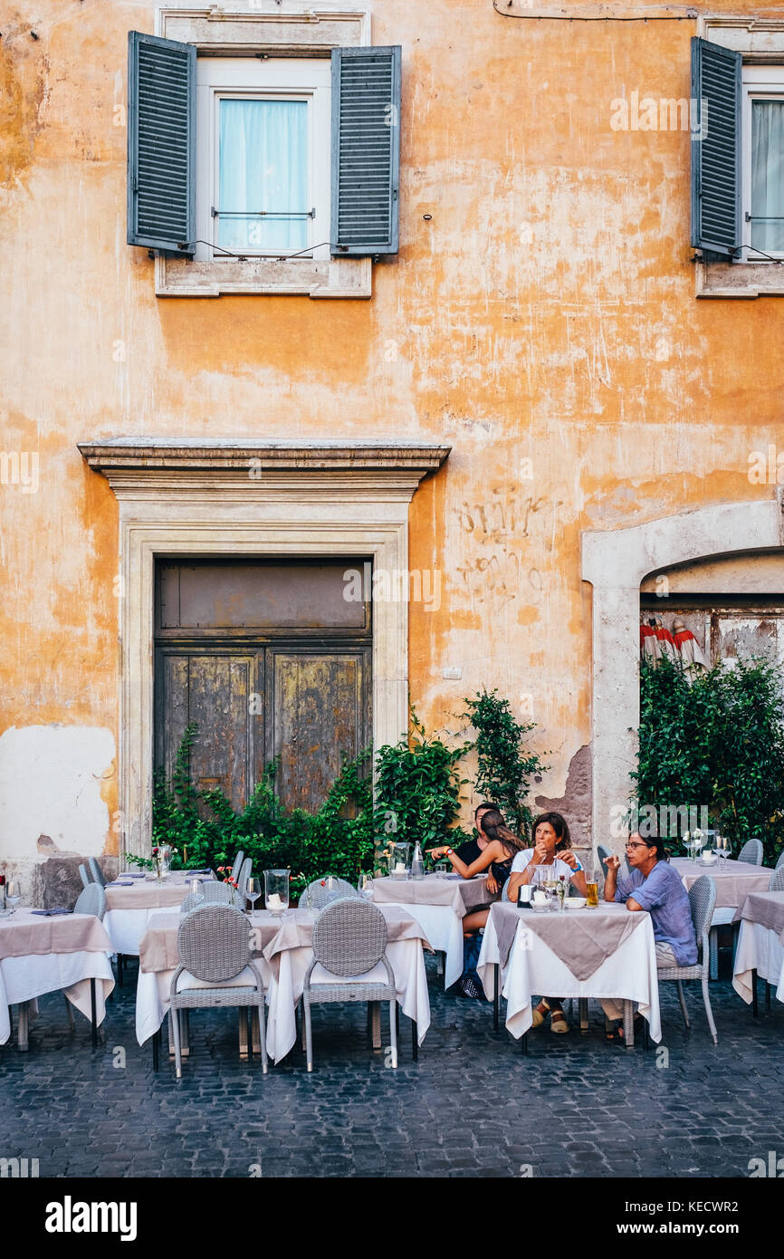 A group of friends sits at an outdoor cafe near the Pantheon in Rome, Italy Stock Photo