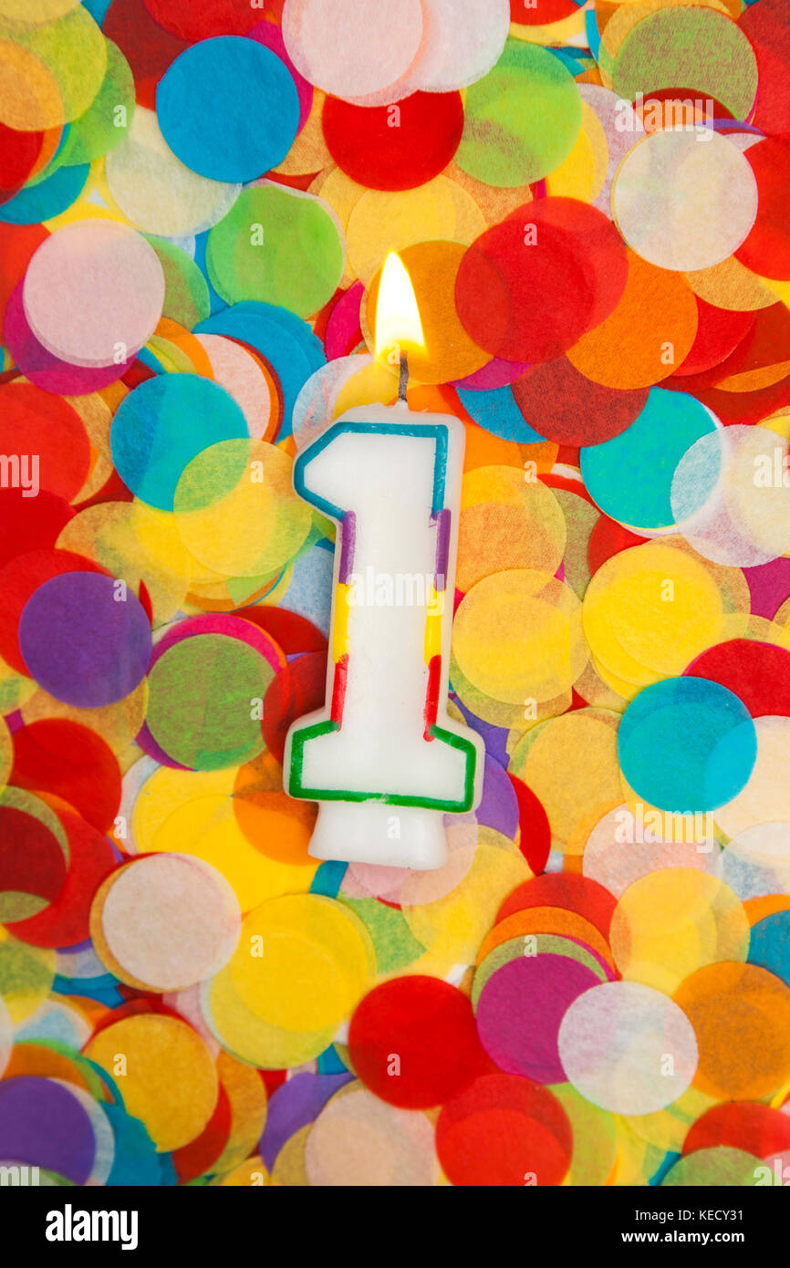 Celebration candle number 1 on a confetti background Stock Photo