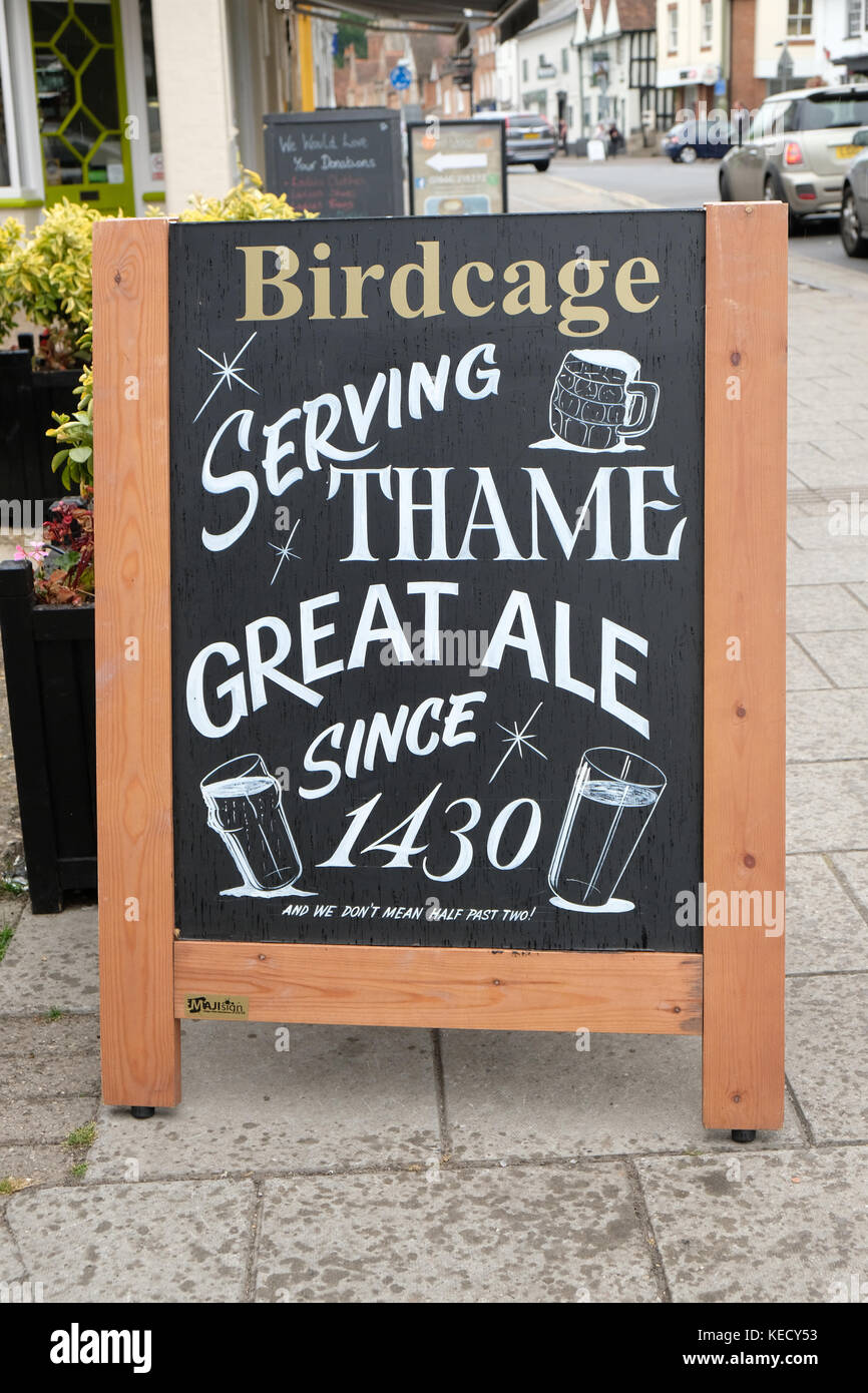 June 2017 - A sign advertising The Birdcage pub in Theme, Oxfordshire. Stock Photo