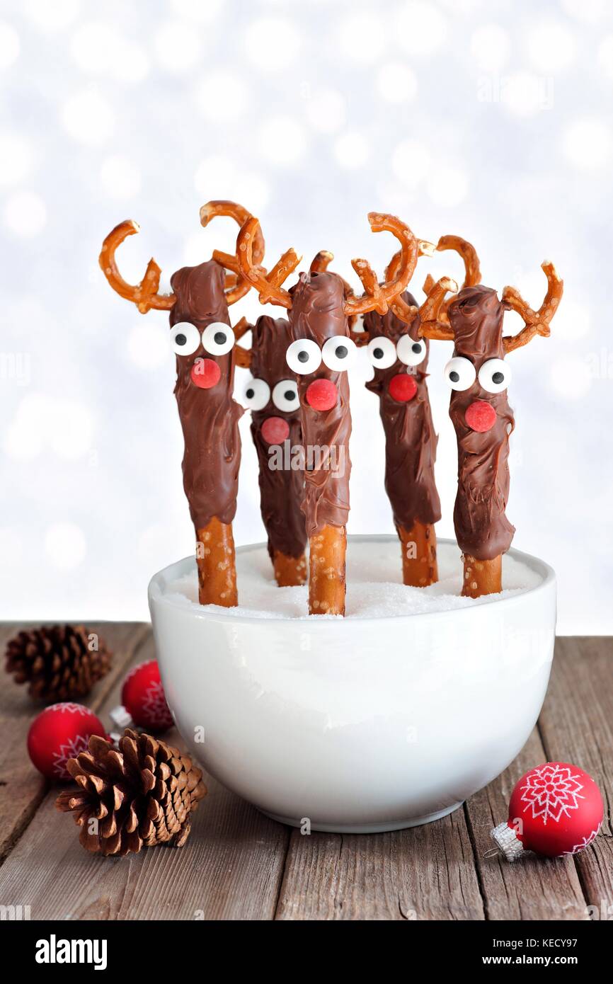 Fun Christmas reindeer chocolate dipped pretzel rods in a bowl with a