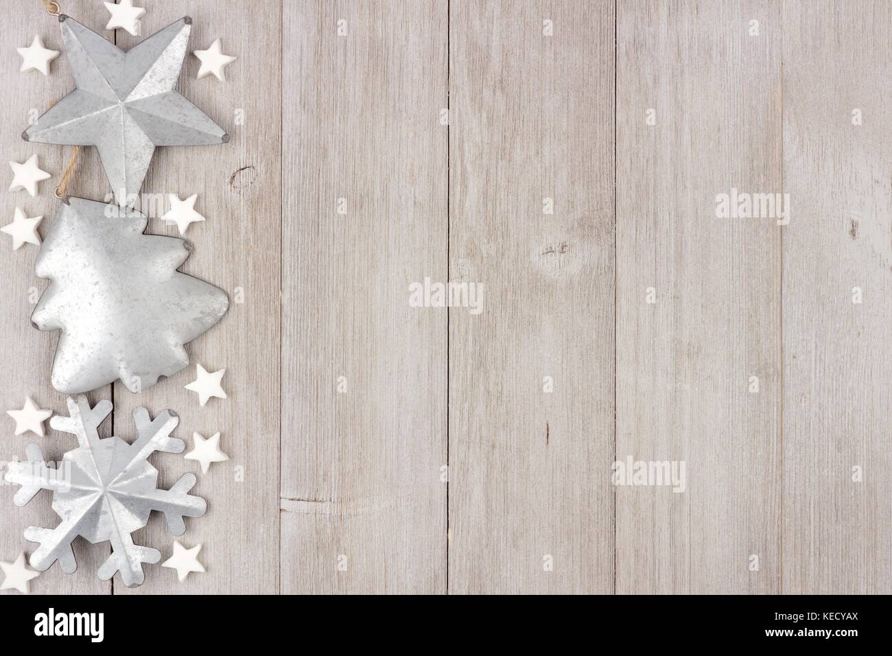 Christmas side border with shabby chic handmade clay and metal ornaments on a rustic wood background Stock Photo