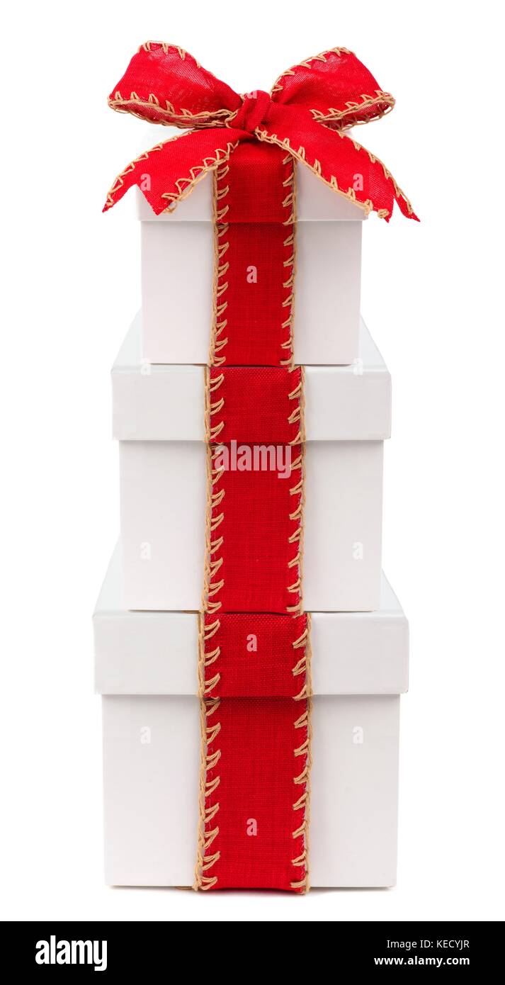 Stacked white Christmas gift boxes wrapped with rustic red bow and ...