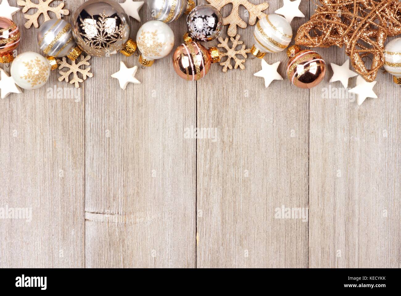 Christmas top border with white and gold ornaments on a rustic wood  background Stock Photo - Alamy