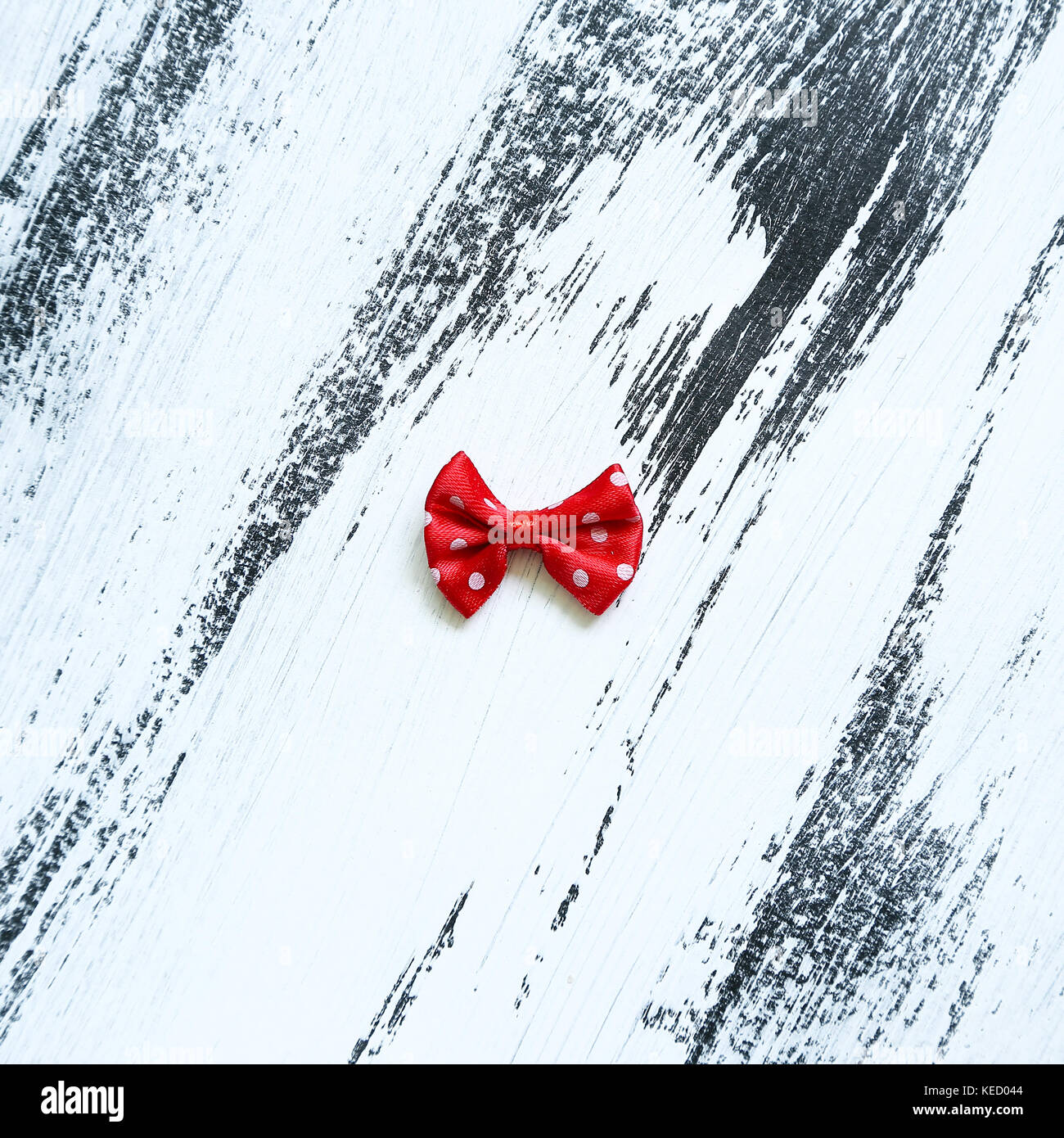Red ribbon on white paint background Stock Photo - Alamy