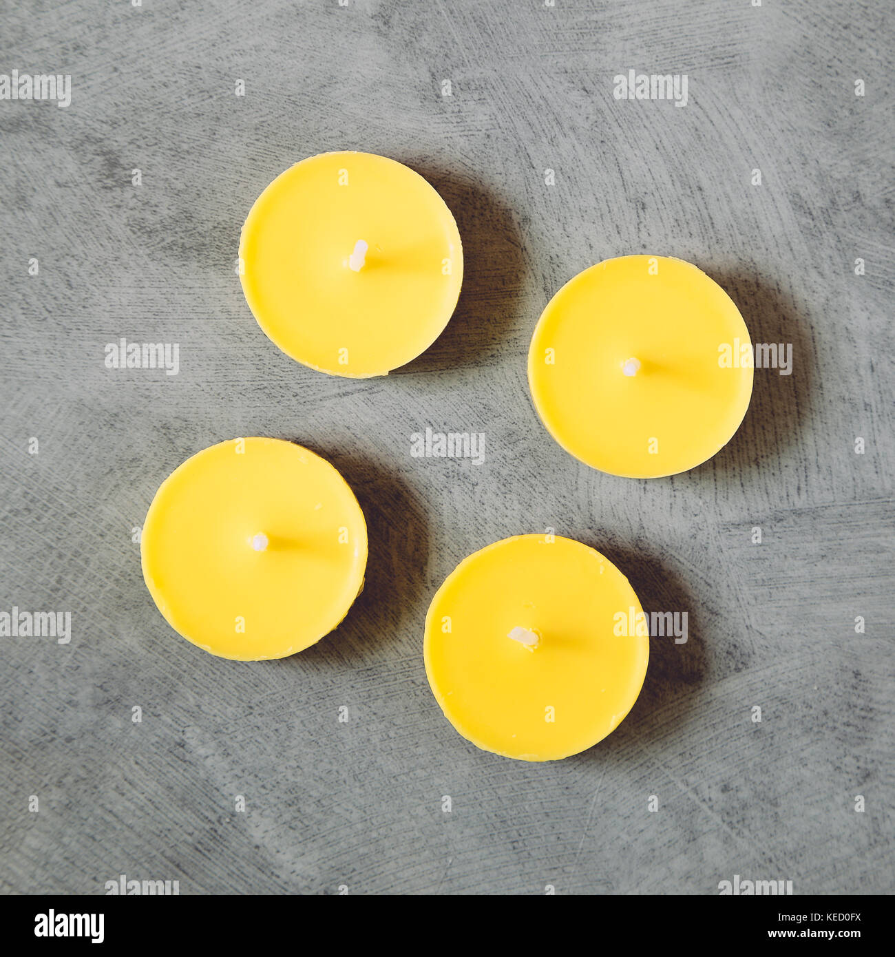 Yellow candles on gray background Stock Photo Alamy