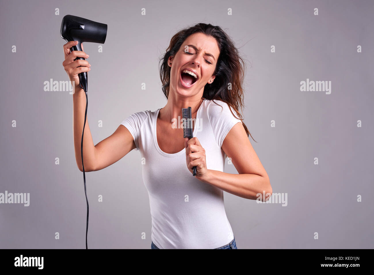 Girl singing into hairbrush hi-res stock photography and images - Alamy