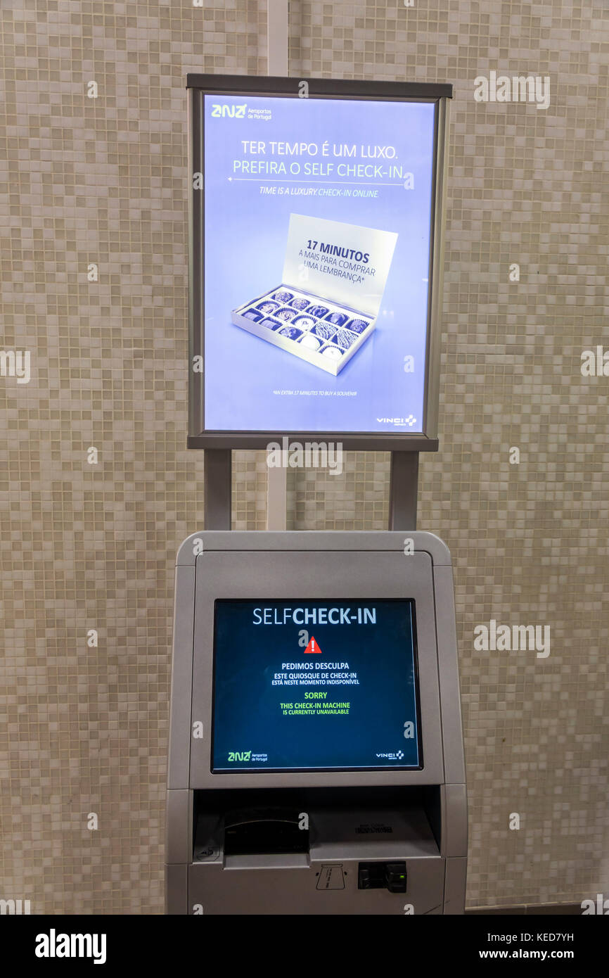 Lisbon Portugal,Humberto Delgado Airport,LIS,Portela Airport,self-service kiosk,self-check-in,machine,out of order,ad,marketing,Hispanic,immigrant imm Stock Photo