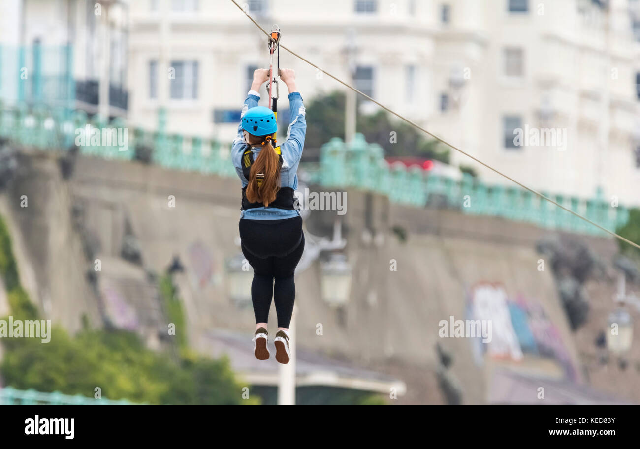 Brighton Zip Wire. A woman riding on the Brighton Zip Line on the seafront in Brighton, East Sussex, England, UK. Stock Photo